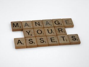 "Manage Your Assets" spelled in game pieces